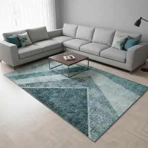Photo of Teal And Ivory Geometric Washable Area Rug With UV Protection