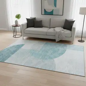 Photo of Teal And Ivory Geometric Washable Area Rug With UV Protection