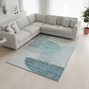 Photo of Teal And Ivory Geometric Washable Area Rug With UV Protection