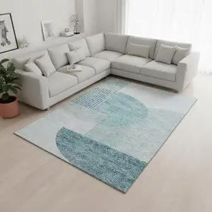 Photo of Teal And Ivory Geometric Washable Area Rug With UV Protection
