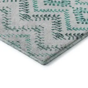 Photo of Teal And Ivory Geometric Washable Area Rug With UV Protection