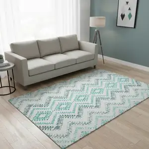 Photo of Teal And Ivory Geometric Washable Area Rug With UV Protection