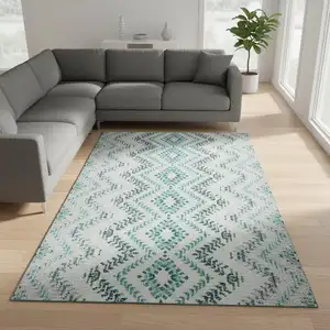 Photo of Teal And Ivory Geometric Washable Area Rug With UV Protection