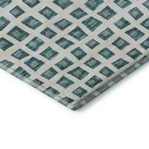 Photo of Teal And Ivory Geometric Washable Area Rug With UV Protection