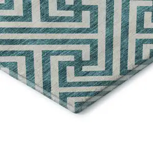 Photo of Teal And Ivory Geometric Washable Area Rug With UV Protection