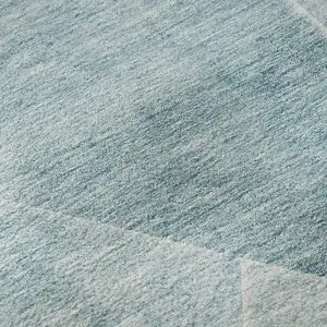 Photo of Teal And Ivory Geometric Washable Area Rug With UV Protection