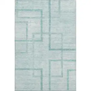 Photo of Teal And Ivory Geometric Washable Area Rug With UV Protection
