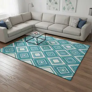 Photo of Teal And Ivory Geometric Washable Area Rug With UV Protection