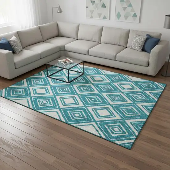 Teal And Ivory Geometric Washable Area Rug With UV Protection Photo 1