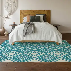 Photo of Teal And Ivory Geometric Washable Area Rug With UV Protection