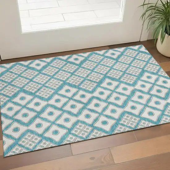 Teal And Ivory Geometric Washable Area Rug With UV Protection Photo 1