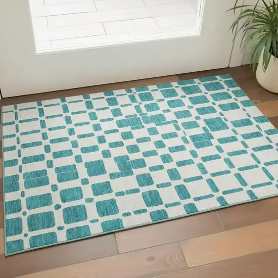 Teal And Ivory Geometric Washable Area Rug With UV Protection Photo 1