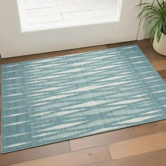 Teal And Ivory Geometric Washable Area Rug With UV Protection Photo 1