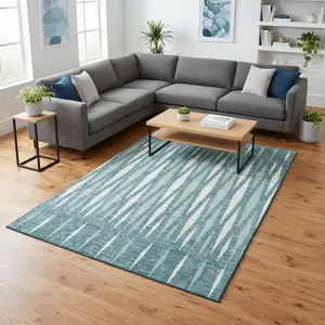 Photo of Teal And Ivory Geometric Washable Area Rug With UV Protection