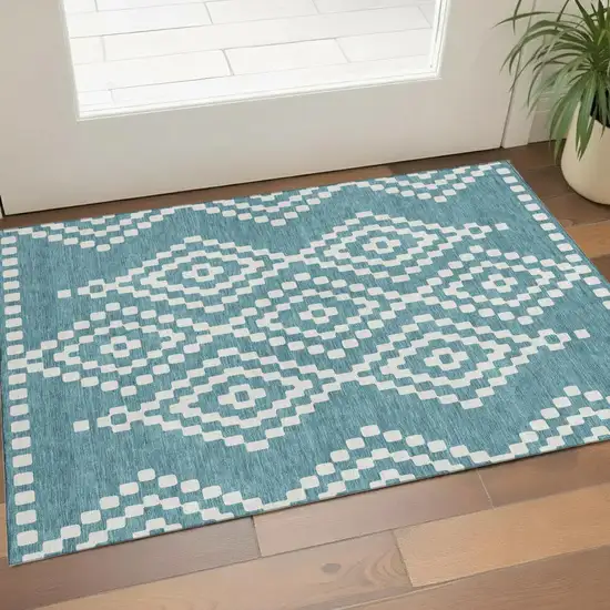 Teal And Ivory Geometric Washable Area Rug With UV Protection Photo 1