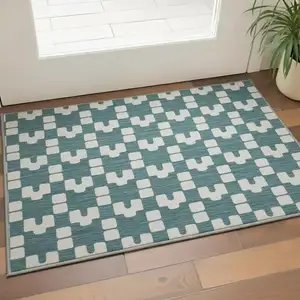 Photo of Teal And Ivory Geometric Washable Area Rug With UV Protection