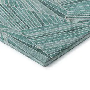 Photo of Teal And Ivory Geometric Washable Area Rug With UV Protection