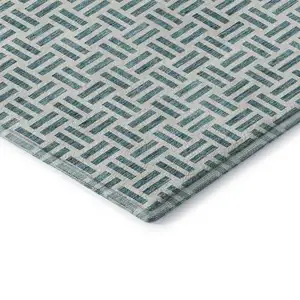 Photo of Teal And Ivory Geometric Washable Area Rug With UV Protection