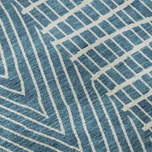 Photo of Teal And Ivory Geometric Washable Area Rug With UV Protection