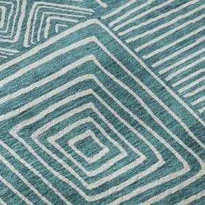 Photo of Teal And Ivory Geometric Washable Area Rug With UV Protection