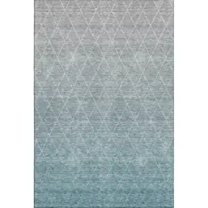 Photo of Teal And Ivory Geometric Washable Area Rug With UV Protection