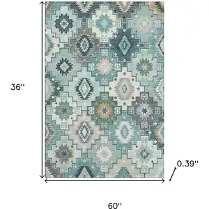 Photo of Teal And Ivory Geometric Washable Area Rug With UV Protection