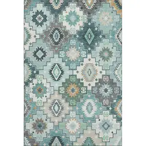 Photo of Teal And Ivory Geometric Washable Area Rug With UV Protection