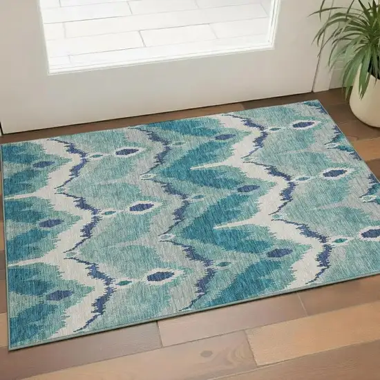 Teal And Ivory Ikat Washable Area Rug With UV Protection Photo 1
