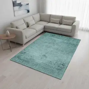 Photo of Teal And Ivory Oriental Washable Area Rug With UV Protection
