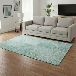 Photo of Teal And Ivory Patchwork Washable Area Rug With UV Protection