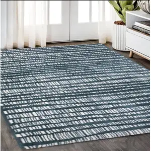 Photo of Teal And Ivory Striped Distressed Area Rug