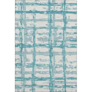 Photo of Teal And Ivory Striped Washable Area Rug With UV Protection