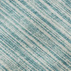 Photo of Teal And Ivory Striped Washable Area Rug With UV Protection