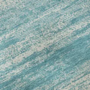 Photo of Teal And Ivory Striped Washable Area Rug With UV Protection