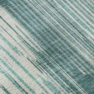 Photo of Teal And Ivory Striped Washable Area Rug With UV Protection