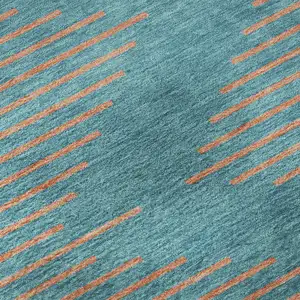 Photo of Teal And Peach Geometric Washable Area Rug With UV Protection