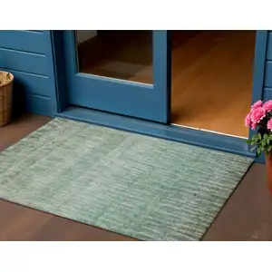 Photo of Teal Blue And Beige Abstract Washable Indoor Outdoor Area Rug