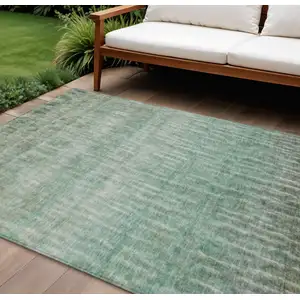 Photo of Teal Blue And Beige Abstract Washable Indoor Outdoor Area Rug