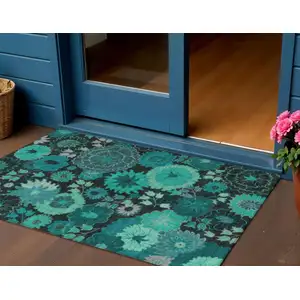 Photo of Teal Blue And Black Floral Washable Indoor Outdoor Area Rug