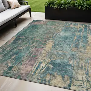Photo of Teal Blue And Gold Abstract Washable Indoor Outdoor Area Rug