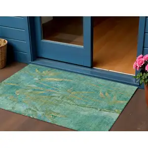 Photo of Teal Blue And Gold Botanical Leaves Washable Indoor Outdoor Area Rug