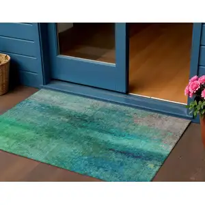 Photo of Teal Blue And Green Abstract Washable Indoor Outdoor Area Rug