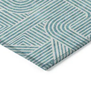 Photo of Teal Blue And Ivory Abstract Washable Indoor Outdoor Area Rug