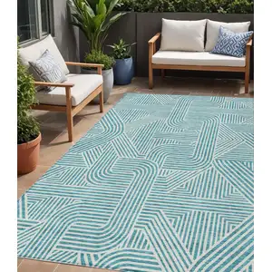 Photo of Teal Blue And Ivory Abstract Washable Indoor Outdoor Area Rug