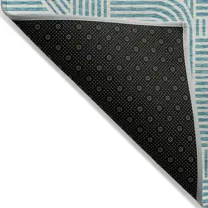 Photo of Teal Blue And Ivory Abstract Washable Indoor Outdoor Area Rug