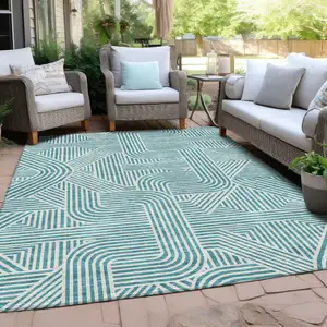 Photo of Teal Blue And Ivory Abstract Washable Indoor Outdoor Area Rug