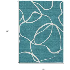 Photo of Teal Blue And Ivory Abstract Washable Indoor Outdoor Area Rug