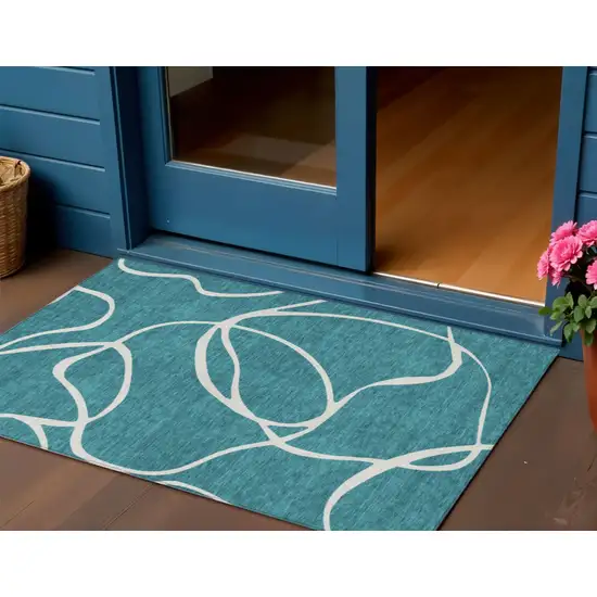 Teal Blue And Ivory Abstract Washable Indoor Outdoor Area Rug Photo 1