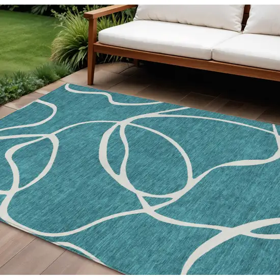 Teal Blue And Ivory Abstract Washable Indoor Outdoor Area Rug Photo 1