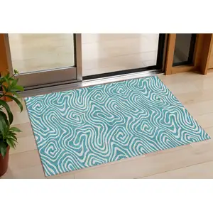 Photo of Teal Blue And Ivory Abstract Washable Indoor Outdoor Area Rug